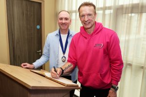 NCBC Guest Speaker Richard Whitehead MBE signs the Guest Book with NCBC President Joe Burns of Reformed IT (left)